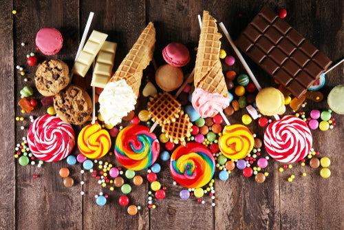 assortment of candies and desserts on table