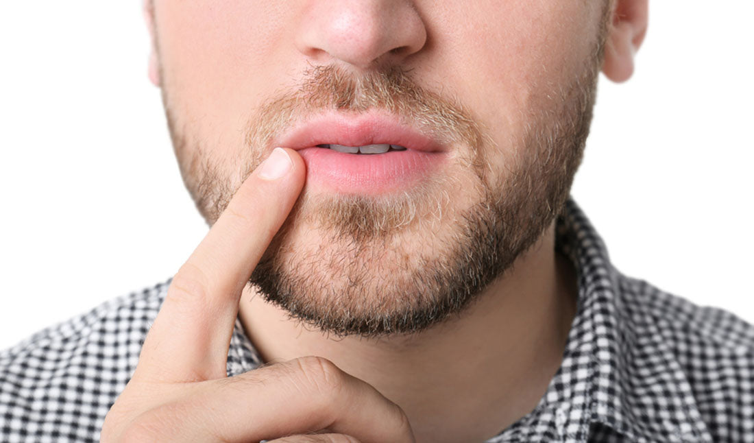 bearded man touching his lips