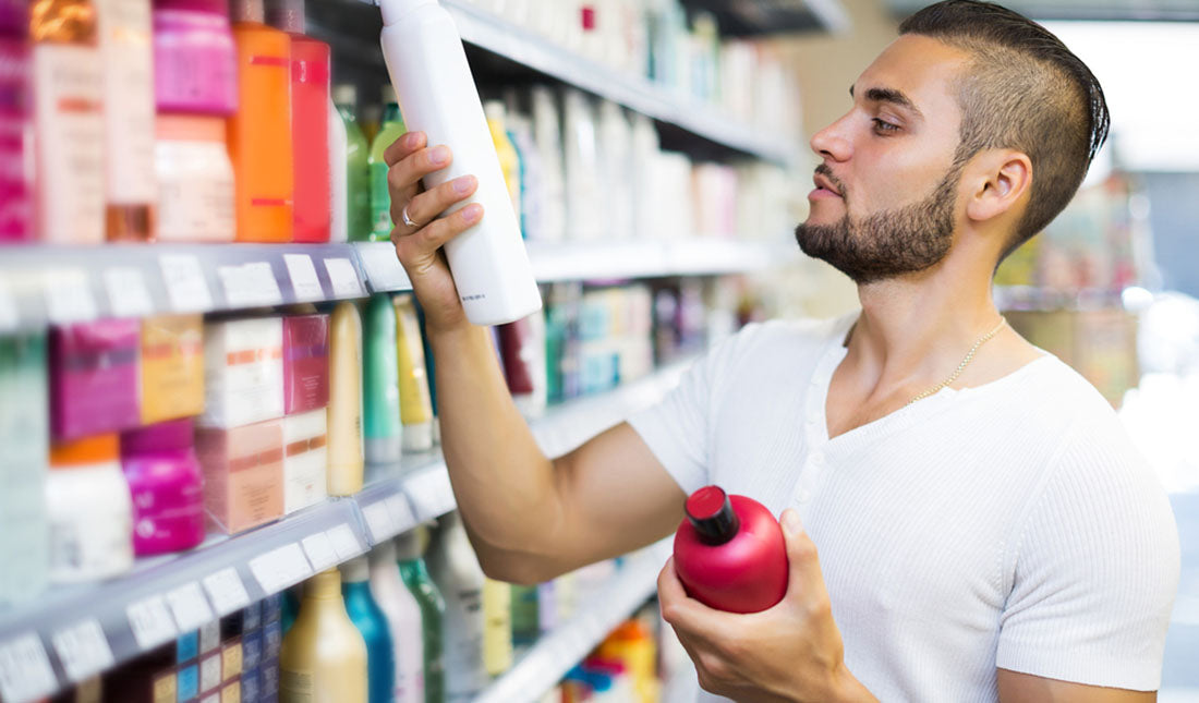 guy choosing shampoo