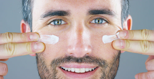 man applying contour cream to face