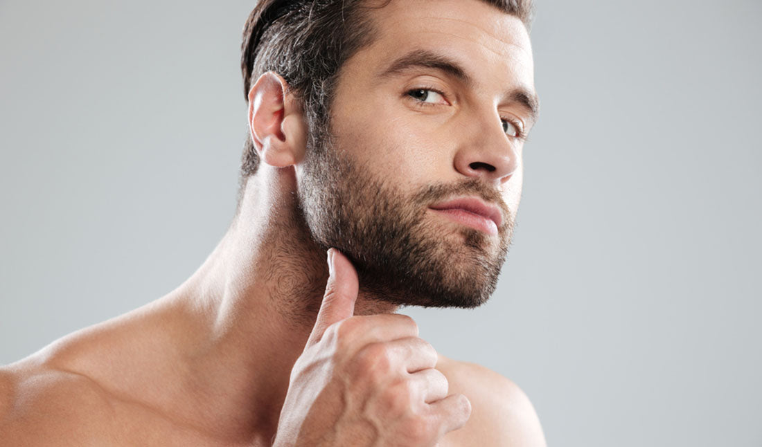 man rubbing beard