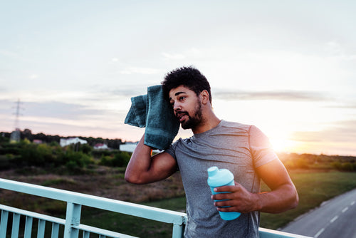 man wiping sweat