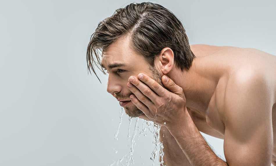 man washing face