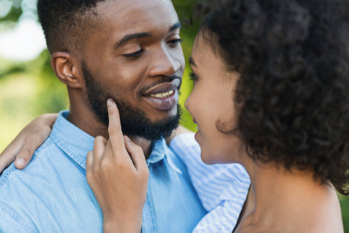 woman touching face of bearded husband