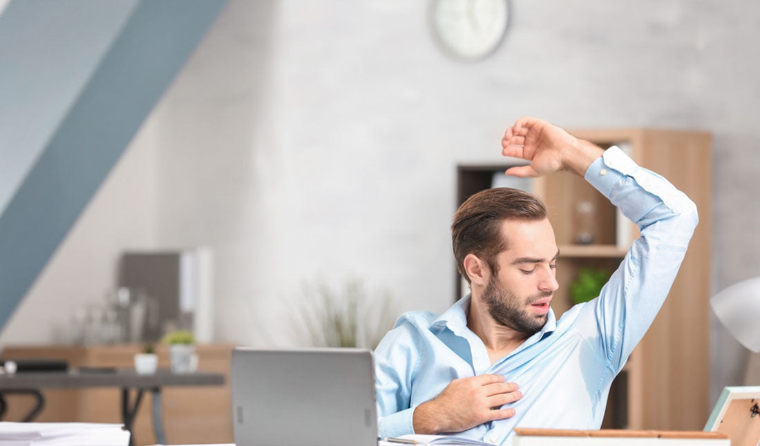 young man sweating in office