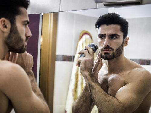 young man using shaving machine