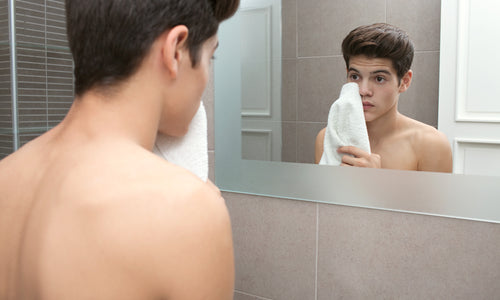 young man washing his face